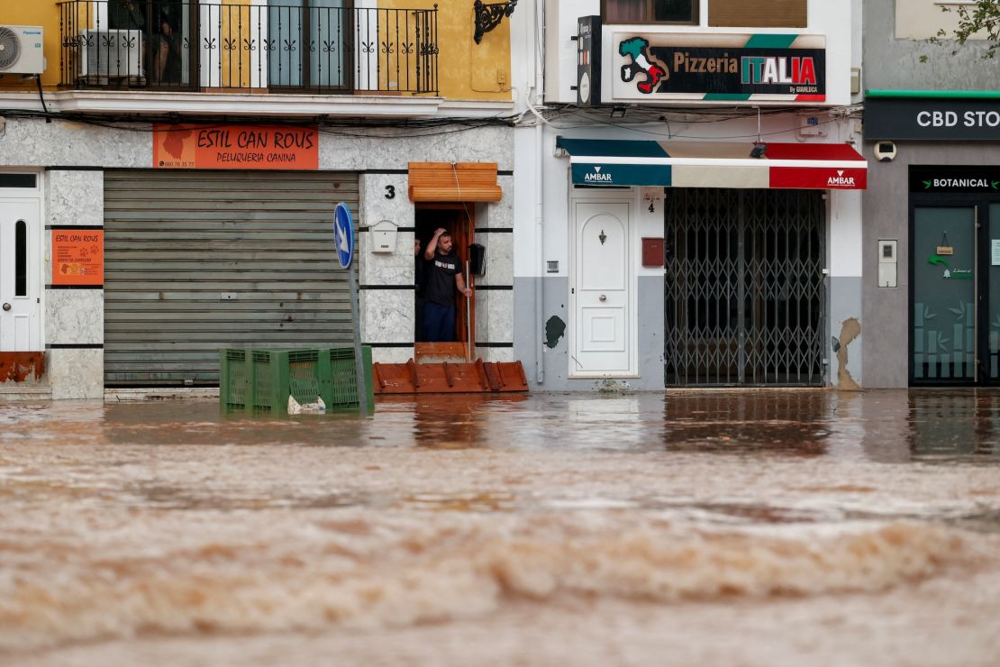 A person reacts to heavy flooding on a street in Valencia, Spain, October 29, 2024.